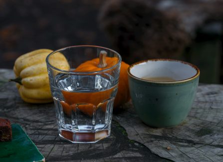 A glass of water sitting on top of a wooden table